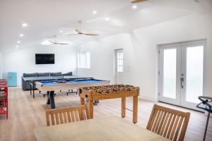 a living room with a ping pong table and a couch at Marina Bay Cottages in Waterford