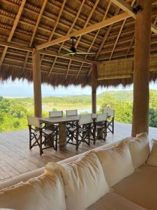 a living room with a table and chairs and a couch at Sumba Farm House in Sumba