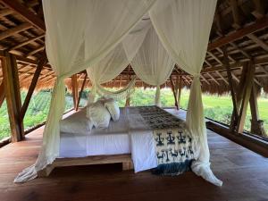 a bedroom with a bed in a tent at Sumba Farm House in Sumba