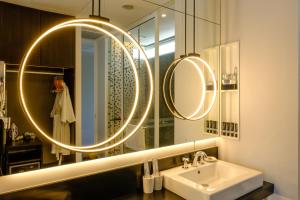a bathroom with a sink and a mirror at Lone Pine, Penang, a Tribute Portfolio Resort in Batu Ferringhi
