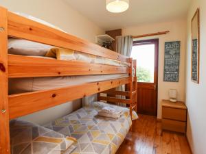 a bedroom with two bunk beds in a house at Dunstanburgh View in Embleton