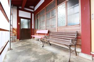 a bench sitting on the side of a building at 民宿やまそ in Takashima