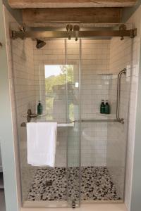 a shower with a glass door in a bathroom at Valley View Cabin in Morris