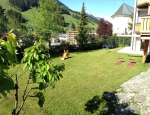 a yard with a playground in the middle of it at Haus Willibald in Saalbach Hinterglemm