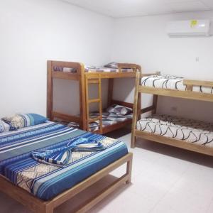 een kamer met 3 stapelbedden in een kamer bij Hospedaje Villa Fati in Coveñas
