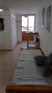 a room with two beds and a table in it at tu lugar 2 in Córdoba +2 photos
