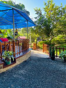 a wooden ramp with a fence and some plants at Poomaz Peace Palace in Ella