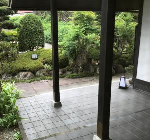 a view of a garden from the inside of a building at Pension Amagiji in Izu