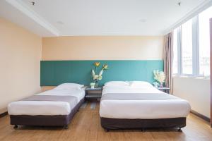 Postel nebo postele na pokoji v ubytování Hotel 28 Titiwangsa