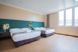 Postel nebo postele na pokoji v ubytování Hotel 28 Titiwangsa