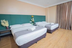 Postel nebo postele na pokoji v ubytování Hotel 28 Titiwangsa