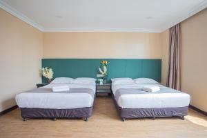 Postel nebo postele na pokoji v ubytování Hotel 28 Titiwangsa