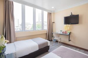 Postel nebo postele na pokoji v ubytování Hotel 28 Titiwangsa