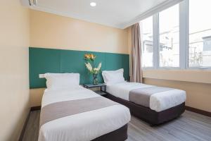 Postel nebo postele na pokoji v ubytování Hotel 28 Titiwangsa