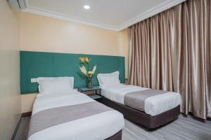 Postel nebo postele na pokoji v ubytování Hotel 28 Titiwangsa