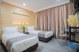 Postel nebo postele na pokoji v ubytování Hotel 28 Titiwangsa