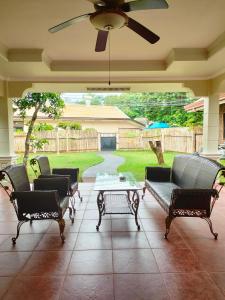 a patio with chairs and a table and an umbrella at DMC2 Residence Panglao in Panglao