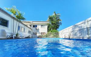 a swimming pool in front of a house at Benayah 3 - Family friendly - Wongaling Beach in South Mission Beach