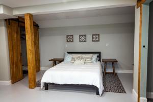 1 dormitorio con 1 cama y 2 mesas. en Valley View Cabin, en Morris