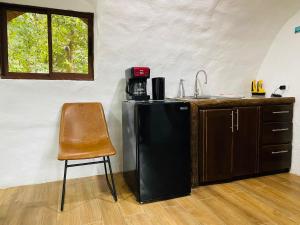a kitchen with a black refrigerator and a chair at Wellness Park CR in Fortuna