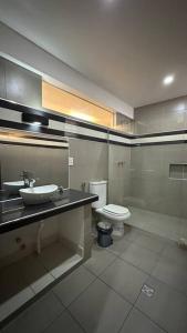 a bathroom with a sink and a toilet at Hermoso y amplio departamento in Tarija