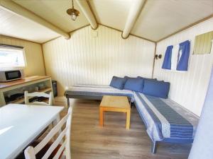 a small room with a bed and a table at Fagervik Camping in Tresfjord