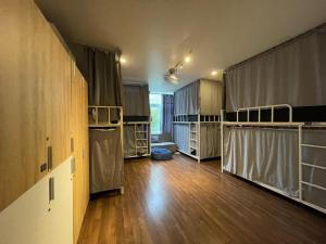a large room with wooden floors and wooden cabinets at Vy Da Backpacker Hostel in Ho Chi Minh City