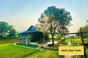 a small house with a tree in front of it at Wonder Farm Ba Vi - Heritage Retreat in Hà Lộc