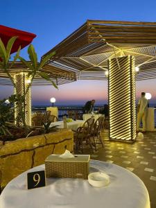 a patio with a table and chairs and a view of the ocean at Grand Palace Hotel in Gaza