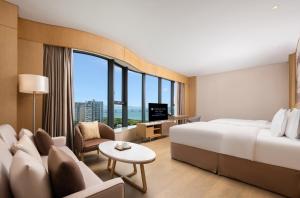 Televiisor ja/või meelelahutuskeskus majutusasutuses Wyndham Grand Plaza Royale Yuzhou Xiamen Wuyuan Bay