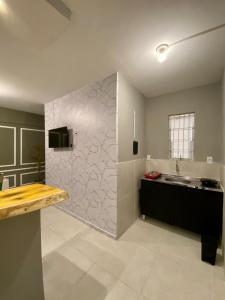 a large kitchen with a sink and a counter at Jr FLATS in João Pessoa