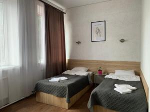 a hotel room with two beds and a window at Hotel Femina in Zhytomyr