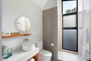 a white bathroom with a sink and a mirror at Reflections Bonny Hills - Holiday Park in Lake Cathie
