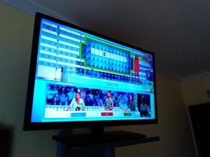a flat screen tv sitting on a stand in a room at A Fontiña in Montalvo