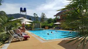 a group of people sitting in a swimming pool at Tamarind Twin Resort in Ko Lanta