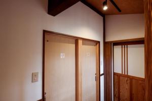 an empty room with a door and a window at ミヤマテラス in Nantan city