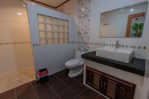 a bathroom with a white sink and a toilet at HOUSE OF HAPPINESS in Thong Sala
