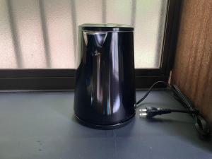 a black blender sitting on a counter next to a window at kamadoma in Kure