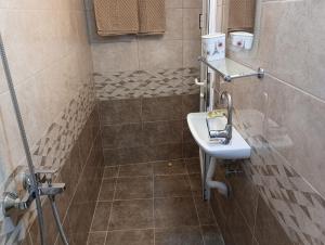 a bathroom with a sink and a shower at При Старото пиано in Belogradchik