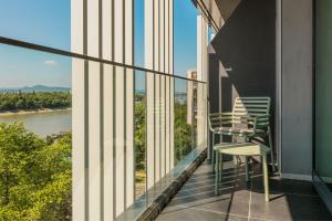 a balcony with chairs and a view of a river at Four Points by Sheraton Budapest Danube in Budapest