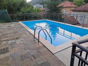 a swimming pool with a metal fence around it at Зеления Осъм Green Osam in Chiflik