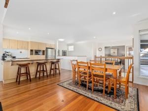 a kitchen and dining room with a table and chairs at Nautica on Marine Parade by Kingscliff Accommodation in Kingscliff