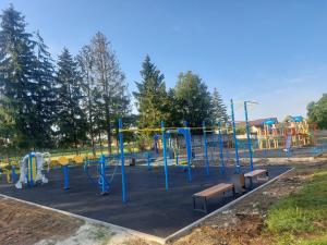 a park with a playground with benches and slides at Готель "ГОСТЬОВИЙ ДІМ in Stryj" in Stryi