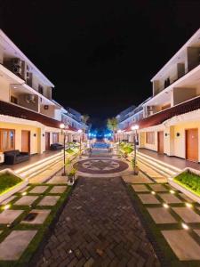 an empty street at night with buildings at Country Heritage Hotel in Surabaya