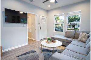 a living room with a couch and a table at Dont Miss Dynamic 4BR2BA Near Jolly Riverwalk in San Antonio