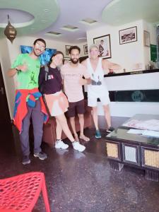 a group of people posing for a picture in a room at Hotel Shree Narayan Palace in Jaipur