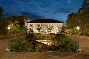 a white building with a bridge in front of it at The Grand Walawwa in Pinnawala