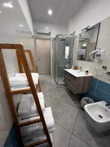 a bathroom with a sink and a toilet and a shower at B&B Lamezia Central Airport in SantʼEufemia Lamezia