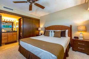 a bedroom with a large bed and a ceiling fan at SUGAR BEACH RESORT, #326 condo in Kihei