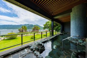 a house with a plunge pool with a view of the water at Grandvrio Hotel Miyajima Wakura - ROUTE INN HOTELS - in Hatsukaichi
